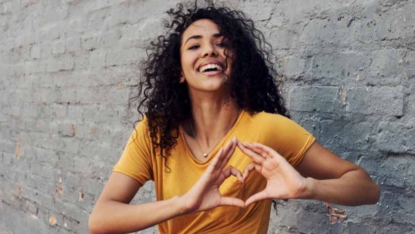 girl drawing a heart with her hands